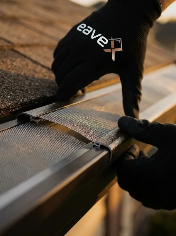 Micro-mesh gutter guard clicking into place on a Maple Grove home